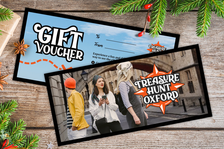 A gift voucher for Treasure Hunt Oxford on a table covered with Christmas decorations